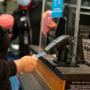 An air traveler uses a credit card to pay for items on January 28, 2022 at a retail shop in John F. Kennedy International Airport in New York City. 