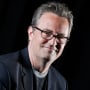 Matthew Perry smiles as he poses for a photograph.