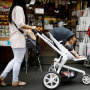 FILE PHOTO: A woman pushing her baby in a stroller shops in the Hongdae area of Seoul