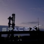 A person takes a photo as SpaceX's mega rocket Starship is prepared for a test flight.