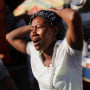 People react at a crime scene, in Port-au-Prince