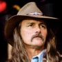 Dickey Betts performs with his guitar