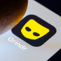 The Grindr app is displayed on a smartphone