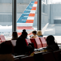 Passengers wait to board a flight 