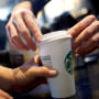 A Starbucks barista fulfills an order in a South Philadelphia store