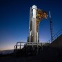 United Launch Alliance Atlas V rocket with Boeing's CST-100 Starliner spacecraft aboard illuminated by spotlights on the launch pad 