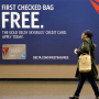 A traveler walks past a sign advertising a Delta Air Lines credit card at Seattle-Tacoma International Airport in 2015