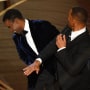 Will Smith, right, slaps Chris Rock onstage during the Oscars 