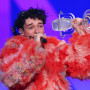 Nemo from Switzerland celebrates with the trophy for winning Eurovision