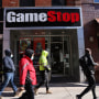 People walk passed a GameStop store in Brooklyn.