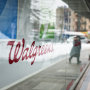 A Walgreens signage is seen on a storefront window.