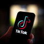 The TikTok logo is seen on a mobile device
