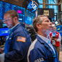 Traders walk the floor during morning trading at the New York Stock Exchange