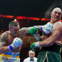 Britain’s Tyson Fury, right, takes a blow from Ukraine’s Oleksandr Usyk