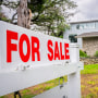 A 'for sale' sign outside a home.