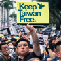 A protestor holds a sign reading "Keep Taiwan Free" during a demonstration