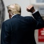 Former President Donald Trump raises his fist as he leaves the courtroom