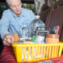 LV Senior man prepares for roadside emergency with survival items in his truck.