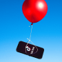 A red balloon carrying a phone with a TikTok logo on it against a blue sky