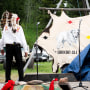 Arvol Looking Horse, a spiritual leader of the Lakota, Dakota and Nakota peoples in South Dakota, left, watches a tarp fall, revealing the name of a recently born white buffalo calf during a naming ceremony for the sacred animal.