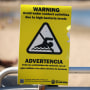 A warning sign for people to avoid the water due to bacteria levels.