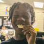 Noah Bush bites into a piece of food