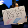 A Transgender rights advocate holds a sign outside the Ohio Statehouse during a rally, in Columbus, Ohio