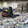 An employee operates a forklift  at a plastics recycling plant in California.