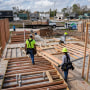 Workers construct a house on Dec. 16, 2024, in Houston.