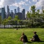 People sit in Brooklyn Bridge park
