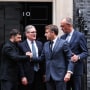 Ukraine's President Volodymyr Zelenskyy, left, and France's President Emmanuel Macron shake hands on the 10 Downing Street doorstep after a meeting with Britain's Prime Minister Keir Starmer, center, and Germany's Chancellor Friedrich Merz, right