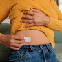 Female Applying HRT Patch for Hormonal Balance