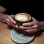 A person holding a cup of coffee