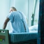 Senior man sitting on hospital bed