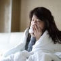 Sick woman blowing her nose
