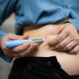Image: Close-up of a person administering semaglutide injection for weight loss.