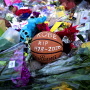 Image: A basketball sits among flowers at a makeshift memorial for Kobe Bryant at Lower Merion High School in Philadelphia on Jan. 27, 2020.