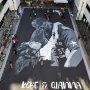 Image: A large drawing shows basketball legend Kobe Bryant and daughter Gianna at a basketball court in Taguig, south of Manila