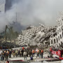 Rescue workers continue their search as smoke rise