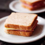 A simple sandwich on white plate.