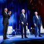 Barack Obama, Joe Biden, and Bill Clinton stand next to each other on stage
