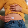 Female Applying HRT Patch for Hormonal Balance