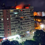 Fire burns on the roof of a 10-story block of flats after a drone crashed into the building in Galati