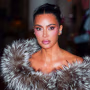 Image: Kim Kardashian with her hair tied back, wearing a fur shawl