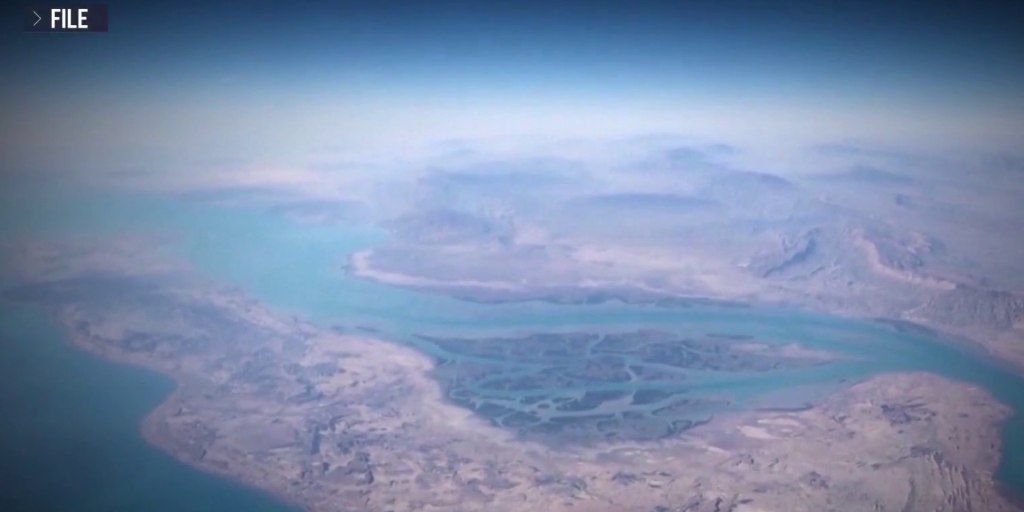 U.S. warship cruises the Strait of Hormuz while Washington pretends this is all a totally normal way to run foreign policy.