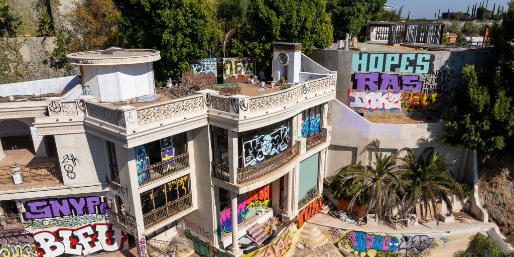 Two abandoned mansions owned by a Hollywood producer are covered in grafitti
