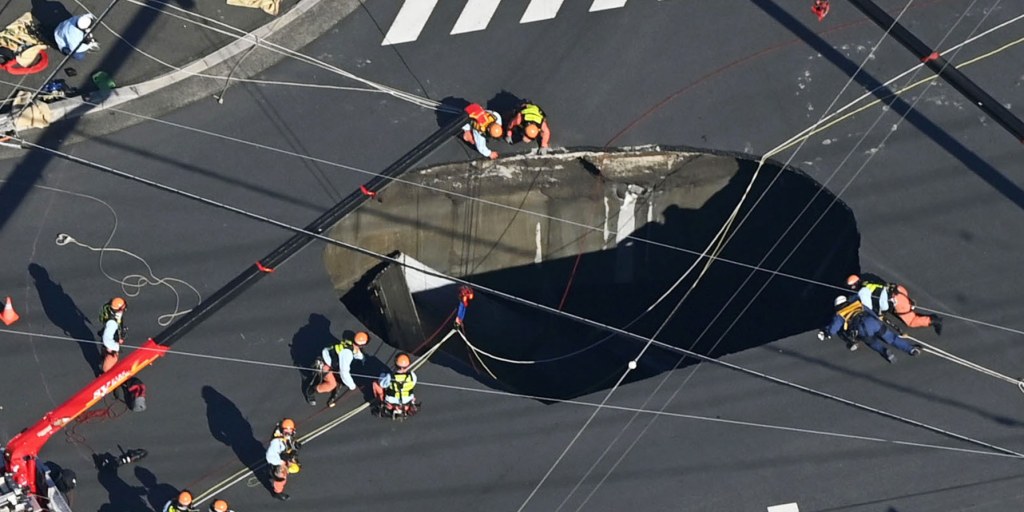 Swimming pool-sized sinkhole swallows truck in Japan, trapping