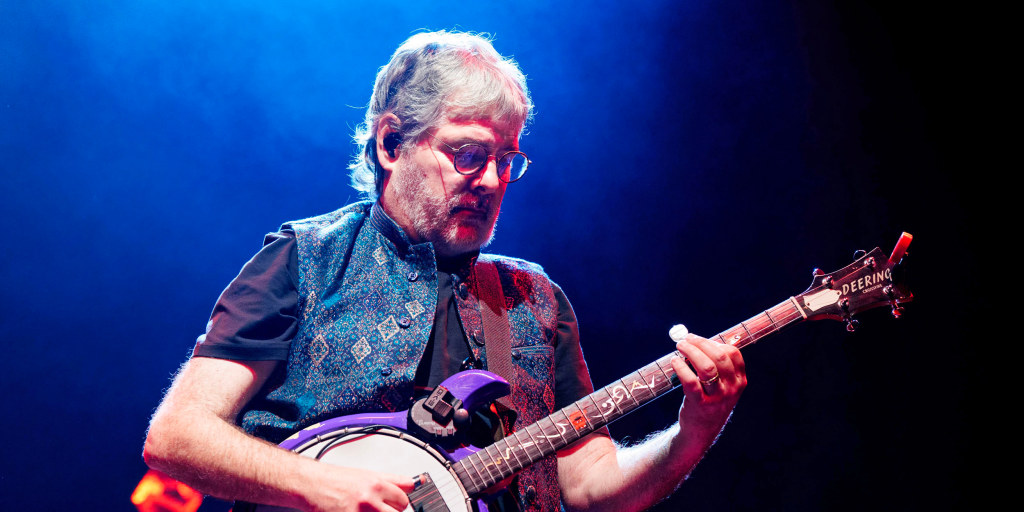 Workers proudly pose in front of the newly installed Trump branding on a JFK memorial, because in 2026 even the buildings have to swear loyalty.