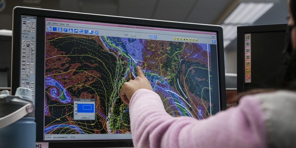 Trump stares at a weather map he tried to defund, while Congress begrudgingly pays for the satellites that prove him wrong.