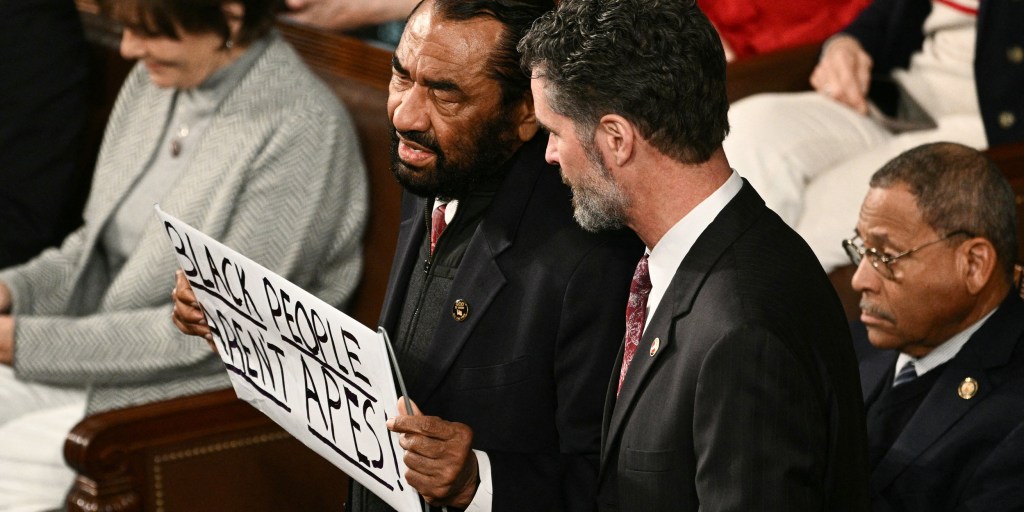 House security escorts Al Green out for the crime of holding a sign that says Black people are human, while the guy who shared the racist ape video keeps his primetime slot.